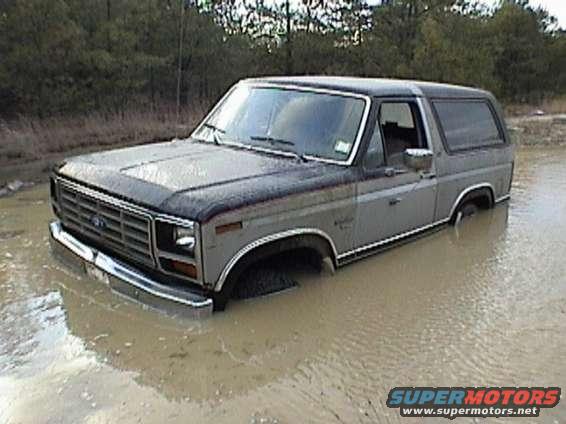 bronco_stuck.jpg The hole wasnt bad, it was the ruts. The wheels were spinning in the water while the bottom of the truck rested on the bottom of the pit. Don't fret, a Ford pulled her right out.
