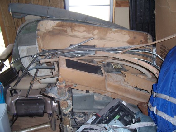 pile of car interior parts, including dashboard pieces and trim