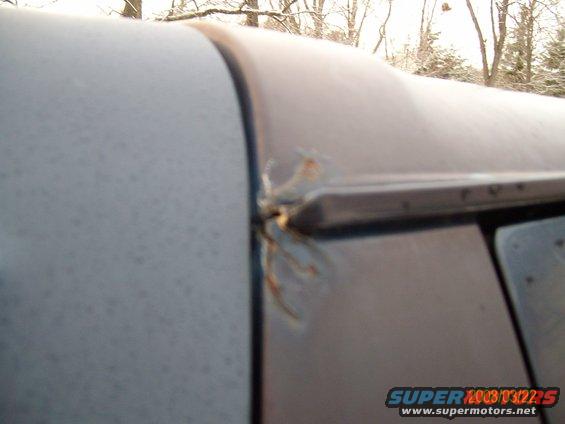 Close-up of rusted seam on gray vehicle roof
