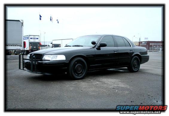 1998 Ford Crown Victoria sedan with a push bumper parked on asphalt