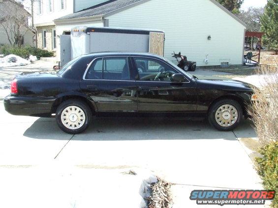 Black 2003 Ford Crown Victoria sedan, side view