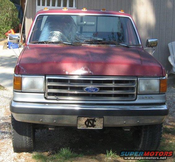Red Ford F-250 truck with a cracked windshield and a "DIESEL" badge
