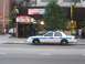1999 Ford Crown Victoria - A 1999 Ford Crown Victoria police car is seen parked on the street in front of a Dunkin' Donuts store.