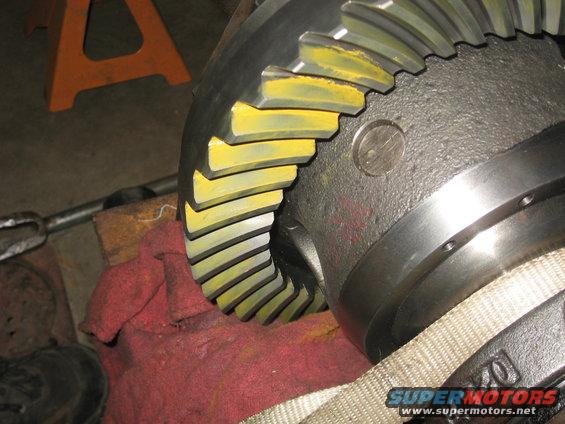 Close-up of a differential ring gear with yellow markings on the teeth