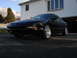 1993 Ford Probe - A black 1993 Ford Probe is shown from a three-quarter front view, parked in a driveway.