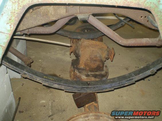 Rusty rear axle assembly with leaf springs and exhaust pipe