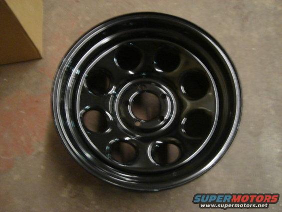Black steel wheel with circular cutouts