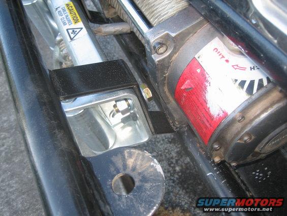 Winch and mounting bracket with caution label