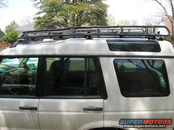 1999 Land Rover Discovery II side view with roof rack and aftermarket wheels