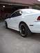 1997 Ford Mustang - This 1997 Ford Mustang is shown from the rear three-quarter angle, highlighting its white paint and black rims.
