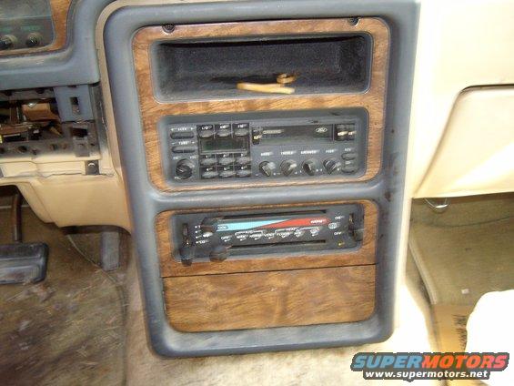 Car interior dashboard with wood trim and dual DIN car stereo