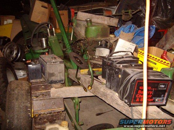 mid-30s-john-deere-mc-crawler.jpg It's hard to tell with all the junk, but there IS a John Deere modle MC crawler under all that stuff. Partialy torn apart for clutch work.