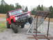 1992 Ford Mustang - A red off-road Bronco is positioned on a metal ramp, its off-road capabilities.