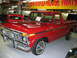 1992 Ford Mustang - A red 1977 Ford F-150 pickup truck is displayed indoors, possibly at a museum or dealership.