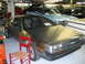 1992 Ford Mustang - DeLorean DMC-12 parked indoors with other classic cars visible in the background.