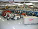 1992 Ford Mustang - A collection of vintage Cushman scooters and motorcycles are displayed in a brightly lit showroom.