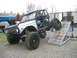 1992 Ford Mustang - Customized Ford Bronco with extreme off-road modifications is positioned on a ramp.
