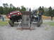 1992 Ford Mustang - Two heavily modified off-road vehicles navigate an obstacle course, one a red Bronco-style vehicle and the other a custom buggy.