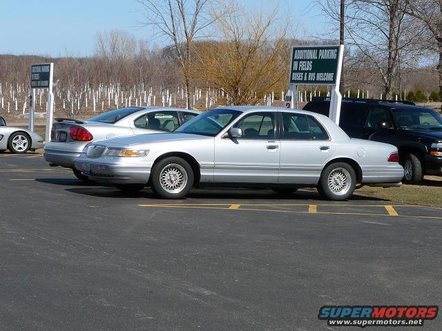 Silver 1997 Mercury Grand Marquis sedan, side view, parked in lot