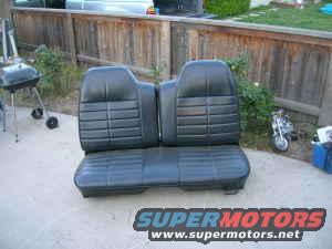 Black vinyl car seat with horizontal pleats, viewed from the front