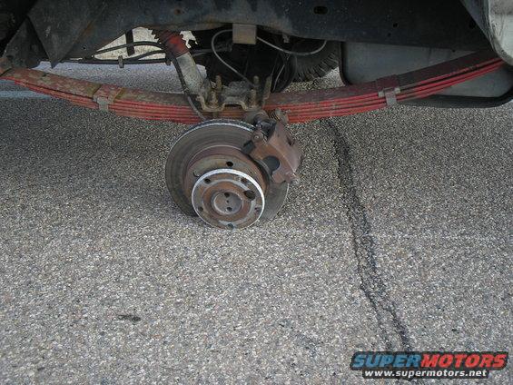 Rear leaf spring and brake rotor assembly on asphalt