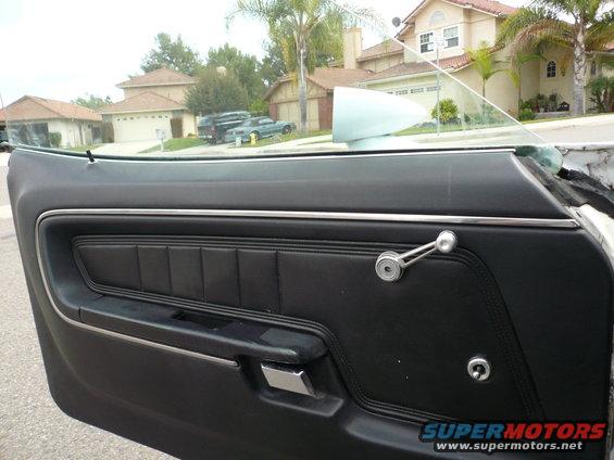 1975 Ford Ranchero interior door panel with chrome window crank and black upholstery