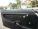 1975 Ford Ranchero - The interior door panel of a 1975 Ford Ranchero features black upholstery and a chrome window crank.