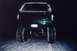 1994 Ford Bronco - Rear view of a dark green SUV with large tires, driving in the snow at night.