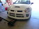 1996 Ford Probe - White Dodge Neon SRT-4 front end with intercoolers visible, being worked on with a floor jack.