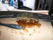 1996 Ford Probe - A damaged car part is being repaired with adhesive and fiberglass material.