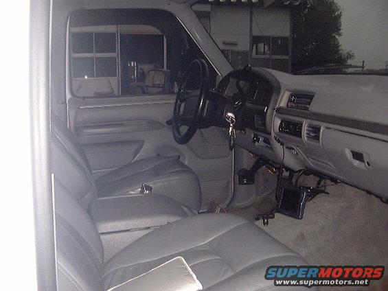 Gray leather interior of a 1992 Ford Bronco, showing front seats, dashboard, and steering wheel