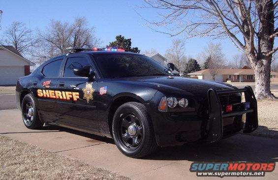 Black sheriff's car with push bar and light bar, side view