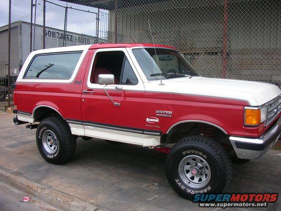 Red and white 1989 Ford Bronco with Rancho suspension