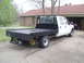 1999 Ford F-350 - White 1999 Ford F-350 truck with a black flatbed is parked in front of a house.