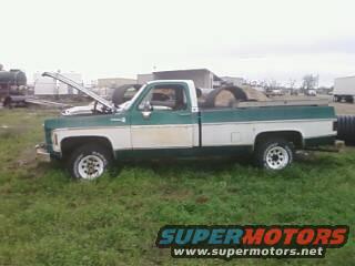Green and white 1973 Chevrolet C/K pickup, side view. Hood is open