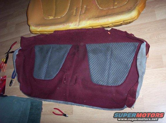 Maroon car seat upholstery with gray striped inserts and foam padding, tools nearby