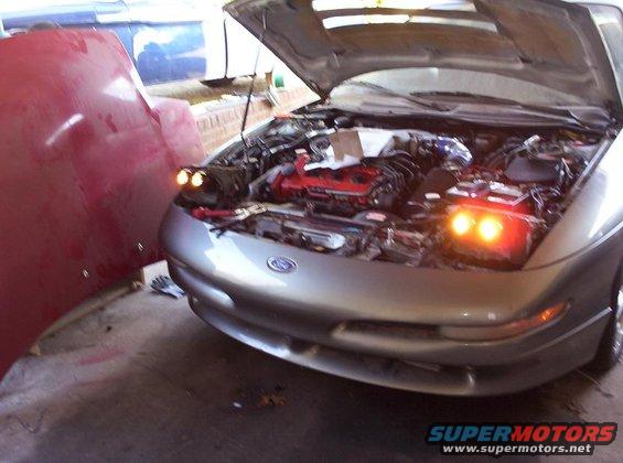 Silver 1995 Ford Probe front view with hood open revealing engine