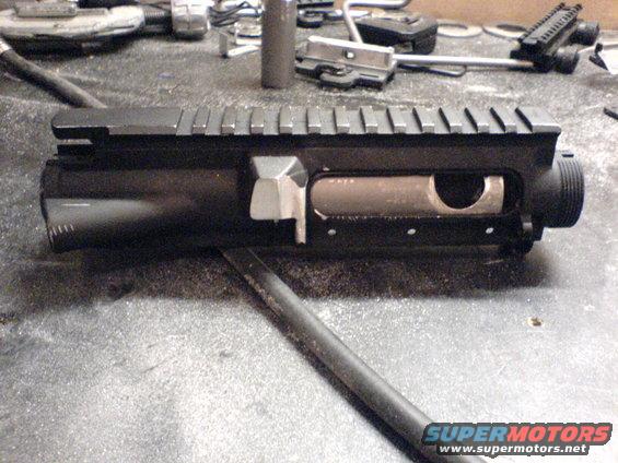 AR-15 upper receiver on a workbench with tools in the background