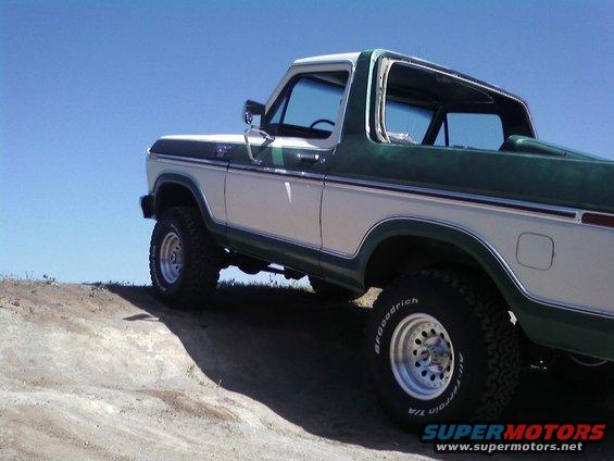 White and green 1978 Ford Bronco on a dirt hill