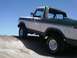 1978 Ford Bronco - This 1978 Ford Bronco is shown from a low angle on a dirt incline under a clear blue sky.