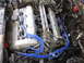 1992 Ford Taurus - Close-up of an engine compartment with prominent blue spark plug wires.