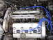 1992 Ford Taurus - Close-up view of a car's engine bay, showing spark plug wires and valve covers.