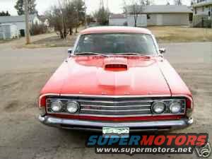 Red 1969 Ford Ranchero front view with hood scoop and dual headlights
