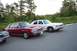 1991 Mercury Marquis - Two full-size sedans are parked in an outdoor lot with trees in the background.