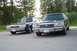 1991 Mercury Marquis - Two Ford Crown Victorias are parked on asphalt with trees in the background.