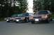 1991 Mercury Marquis - Three sedans, including a red 1991 Mercury Marquis, are parked in a lot.