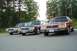 1991 Mercury Marquis - Three Ford Crown Victorias from the 1980s are lined up in a parking lot with trees in the background.
