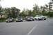 1991 Mercury Marquis - Four sedans are parked in a line on an asphalt surface with trees in the background.