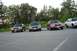 1991 Mercury Marquis - Multiple sedans are parked in a line on an asphalt surface with a wooded area behind them.