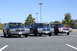 1991 Mercury Marquis - Three 1991 Mercury Marquis sedans are lined up in a parking lot under a clear blue sky.